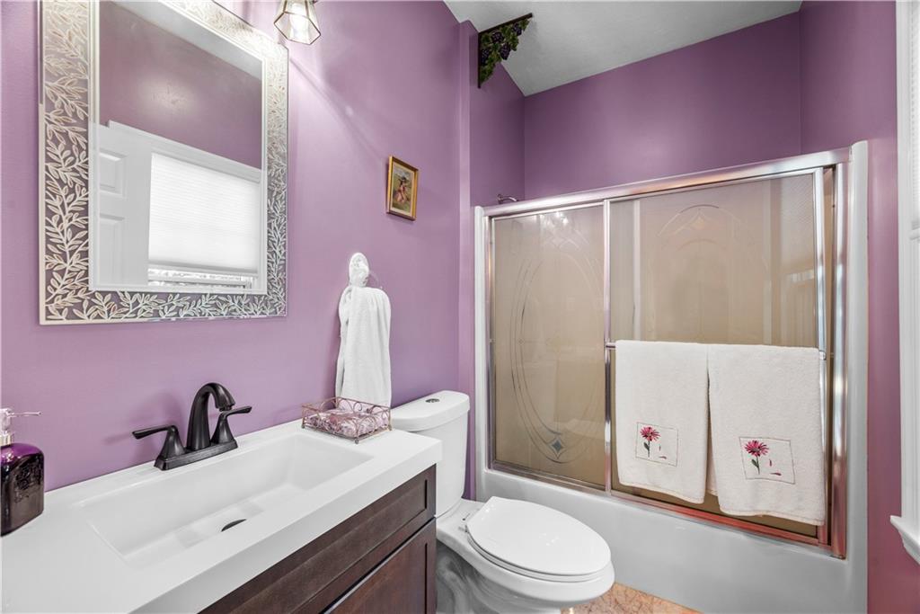 747 Achortown Road Beaver Falls, PA 15010 - Photo 8 of 28 a bathroom with a sink vanity mirror and toilet