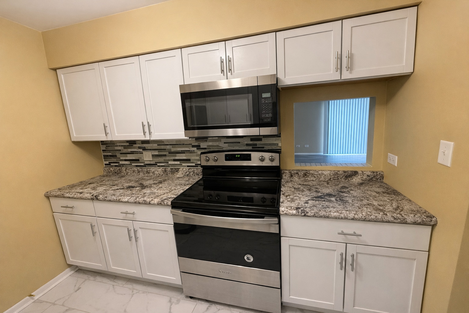 1462 Stonebridge Circle, Unit F10 Wheaton, IL 60189 - Photo 8 of 19 a kitchen with granite countertop a stove microwave and sink