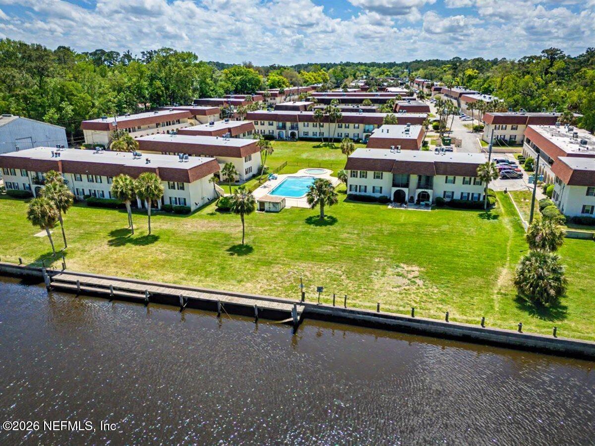 1540 El Prado Road, Unit 4 Jacksonville, FL 32216 - Photo 13 of 14 a view of a swimming pool with a garden and lake view