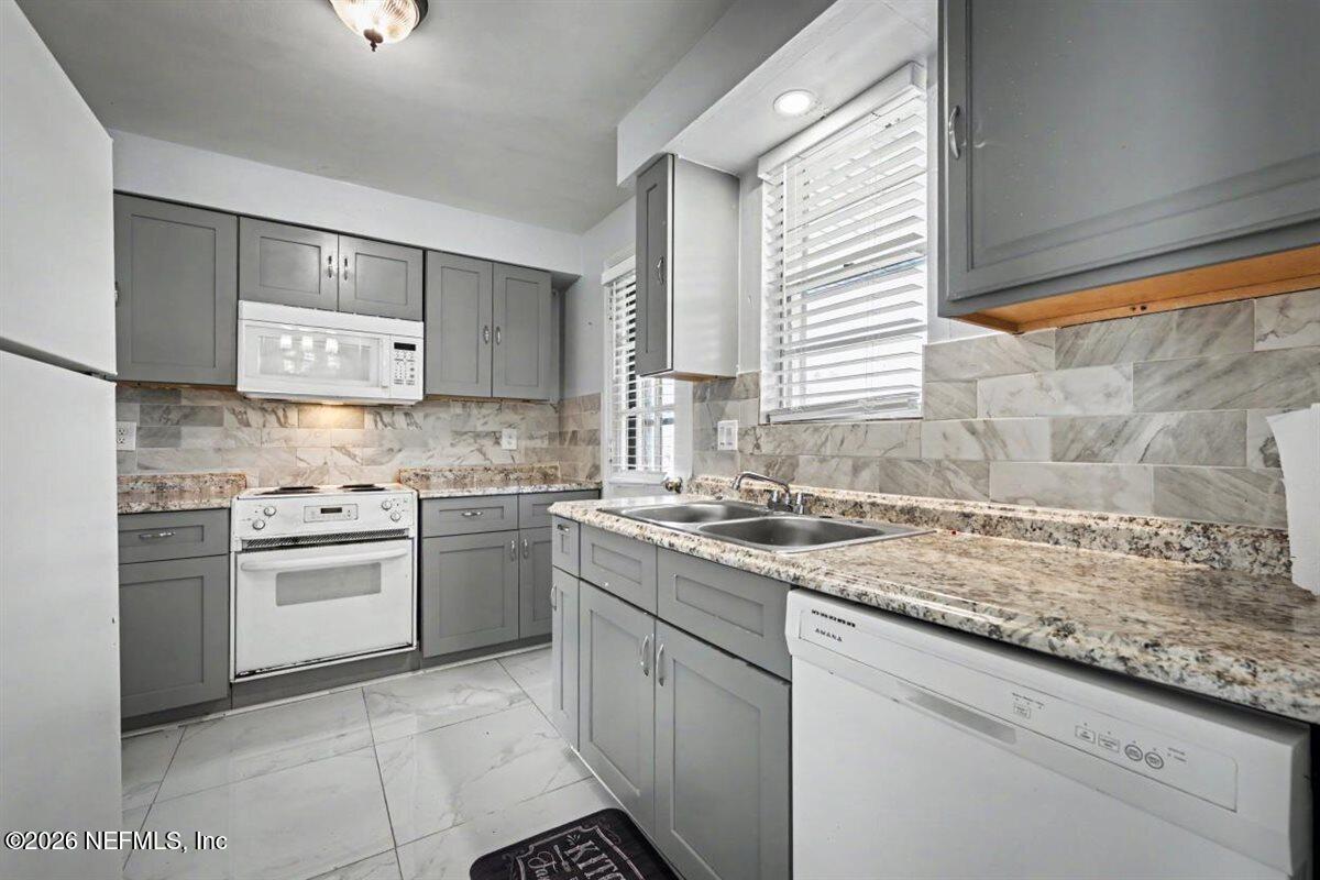 1540 El Prado Road, Unit 4 Jacksonville, FL 32216 - Photo 4 of 14 a kitchen with a sink stove and cabinets