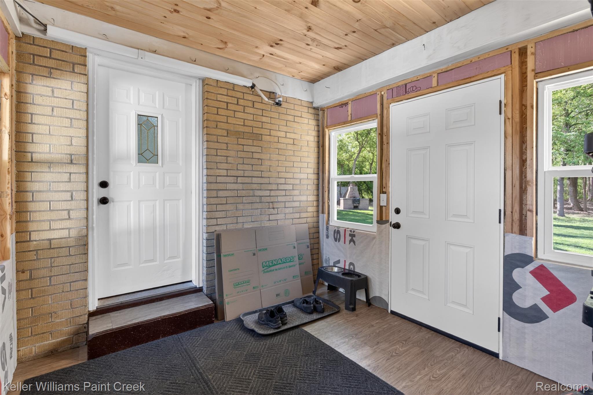 2942 Tatham Road Saginaw, MI 48601 - Photo 28 of 59 Foyer with brick wall, wood ceiling, dark wood-type flooring, and plenty of natural light