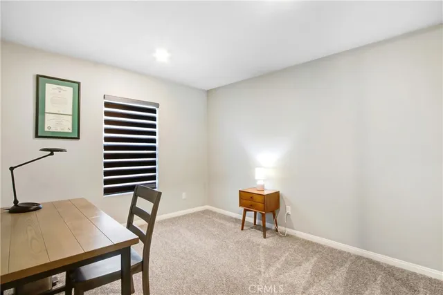 a view of a room with a table and chairs