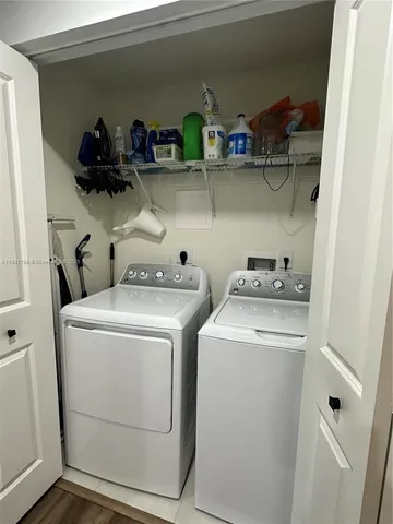 a view of storage and utility room with washer and dryer