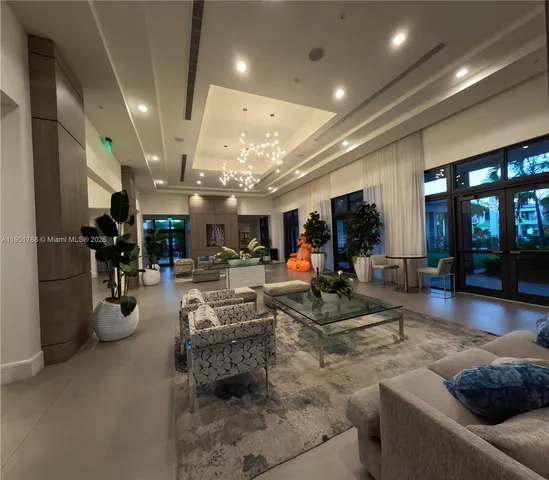 a living room with furniture and a large mirror