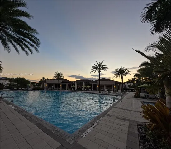 a view of a swimming pool with an outdoor space and seating area