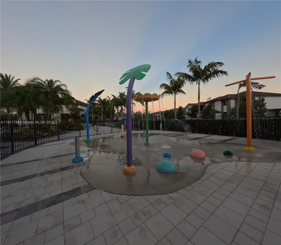 a view of a swimming pool with a patio and a garden