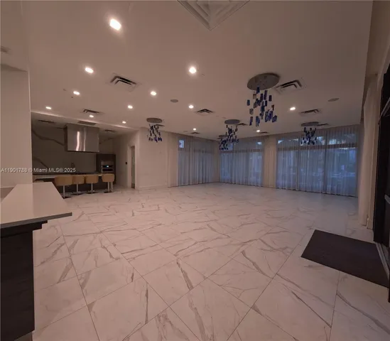 a view of kitchen with furniture and a refrigerator