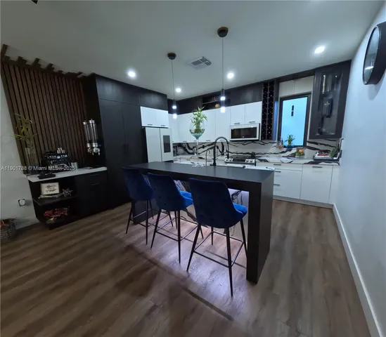 a kitchen with a table and chairs in it