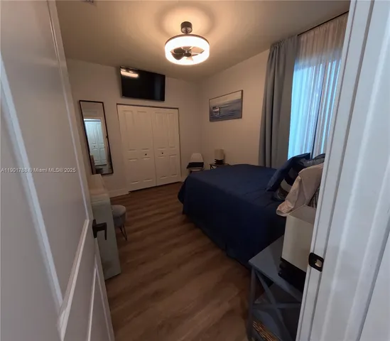 a bedroom with a bed and a mirror