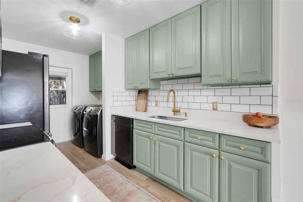 30024 Tavares Ridge Boulevard, Unit 62 Tavares, FL 32778 - Photo 11 of 31 a kitchen with stainless steel appliances granite countertop a sink a stove and cabinets