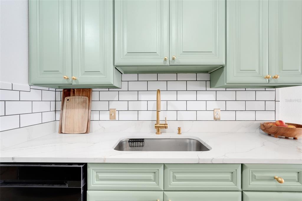30024 Tavares Ridge Boulevard, Unit 62 Tavares, FL 32778 - Photo 12 of 31 a kitchen with a sink and cabinets