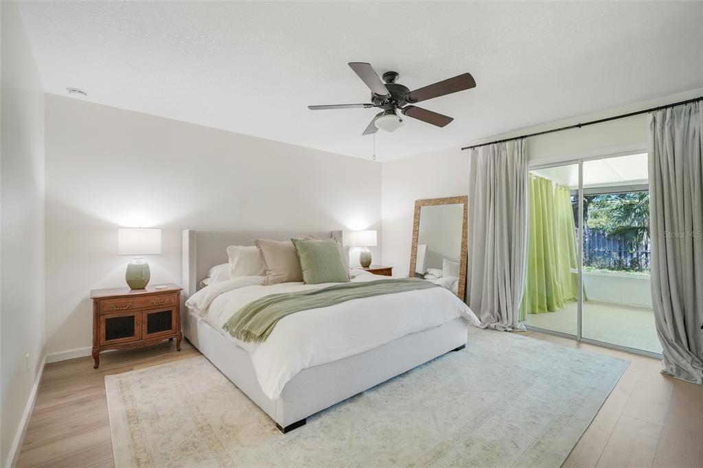 30024 Tavares Ridge Boulevard, Unit 62 Tavares, FL 32778 - Photo 15 of 31 a spacious bedroom with a bed and a chandelier