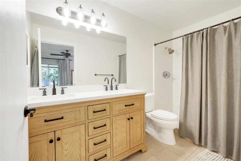 30024 Tavares Ridge Boulevard, Unit 62 Tavares, FL 32778 - Photo 19 of 31 a bathroom with a double vanity sink mirror and toilet