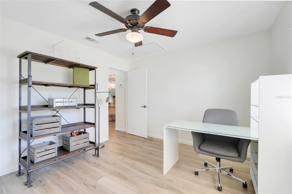 30024 Tavares Ridge Boulevard, Unit 62 Tavares, FL 32778 - Photo 20 of 31 a view of a workspace with furniture and a ceiling fan