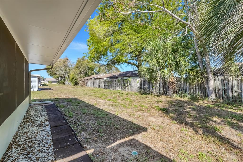 30024 Tavares Ridge Boulevard, Unit 62 Tavares, FL 32778 - Photo 27 of 31 a view of a yard with plants