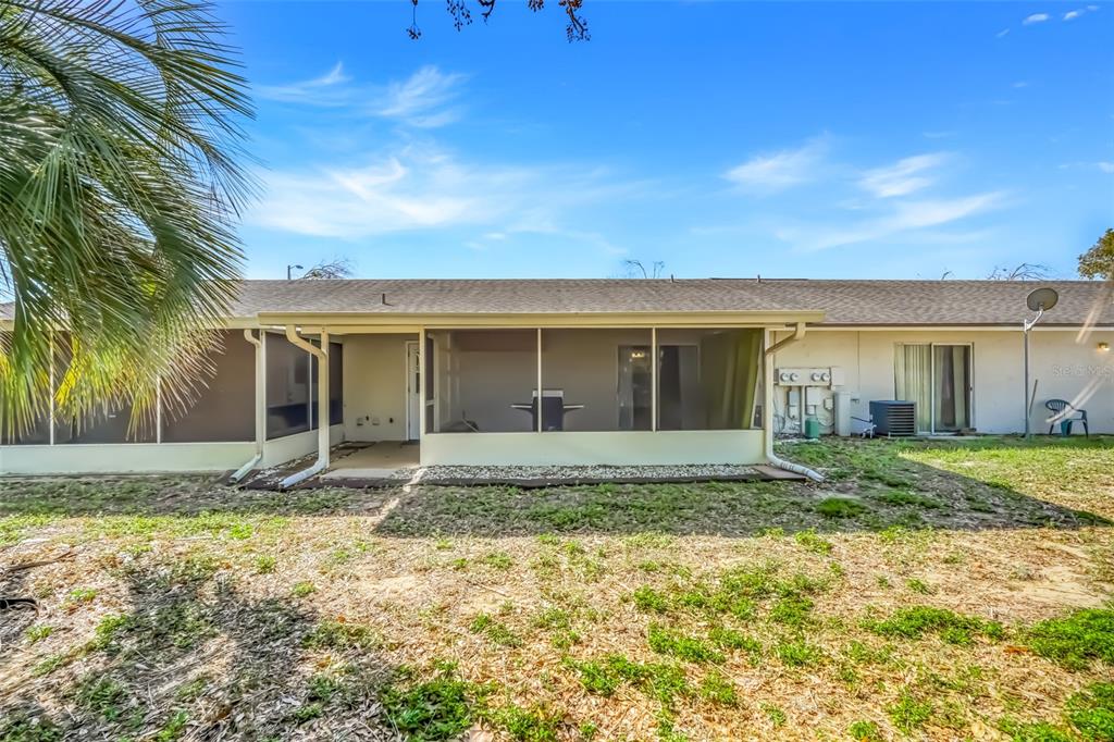30024 Tavares Ridge Boulevard, Unit 62 Tavares, FL 32778 - Photo 29 of 31 a view of a house with a yard and large tree