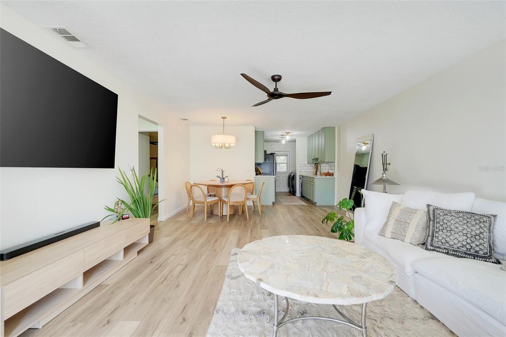 30024 Tavares Ridge Boulevard, Unit 62 Tavares, FL 32778 - Photo 3 of 31 a living room with furniture and a flat screen tv