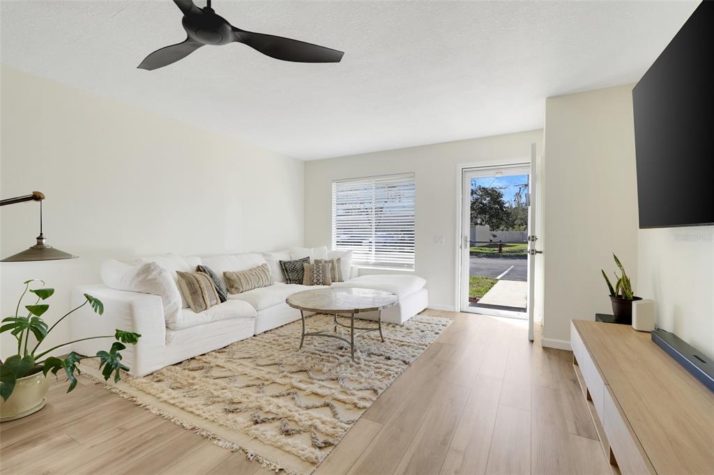 30024 Tavares Ridge Boulevard, Unit 62 Tavares, FL 32778 - Photo 4 of 31 a living room with furniture and a large window