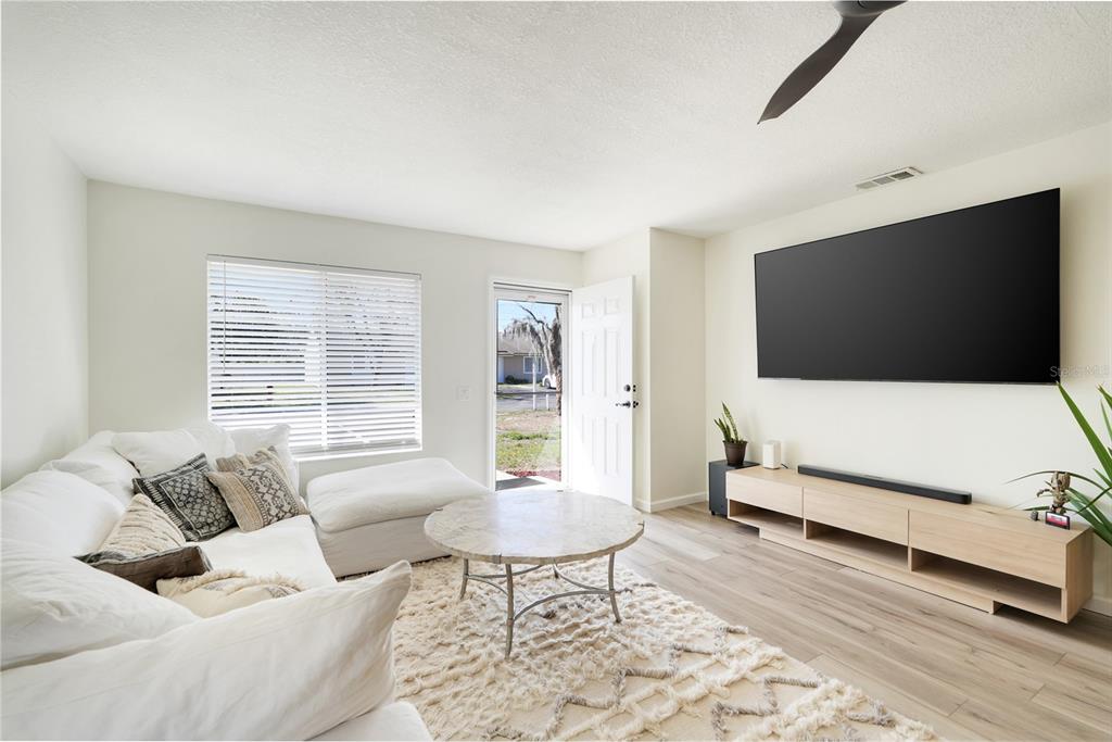 30024 Tavares Ridge Boulevard, Unit 62 Tavares, FL 32778 - Photo 5 of 31 a living room with furniture and a flat screen tv