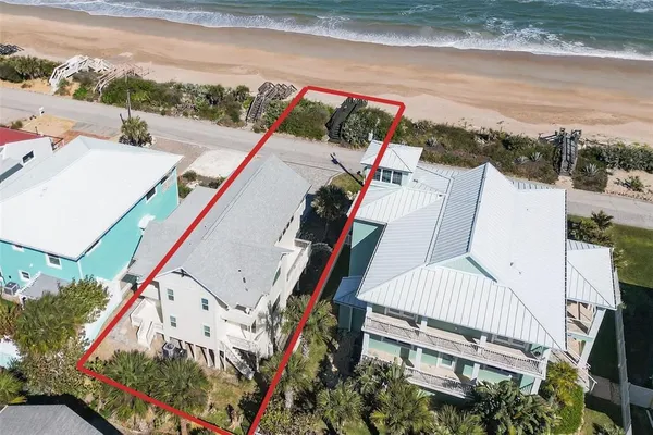 an aerial view of multiple houses with yard