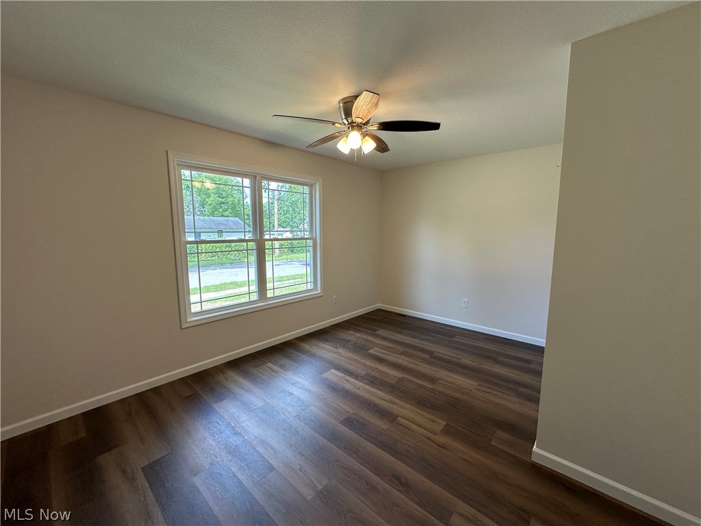 78 Prospect Street Struthers, OH 44471 - Photo 11 of 17 LTV flooring, white trim, double window, and a ceiling fan with integrated lighting