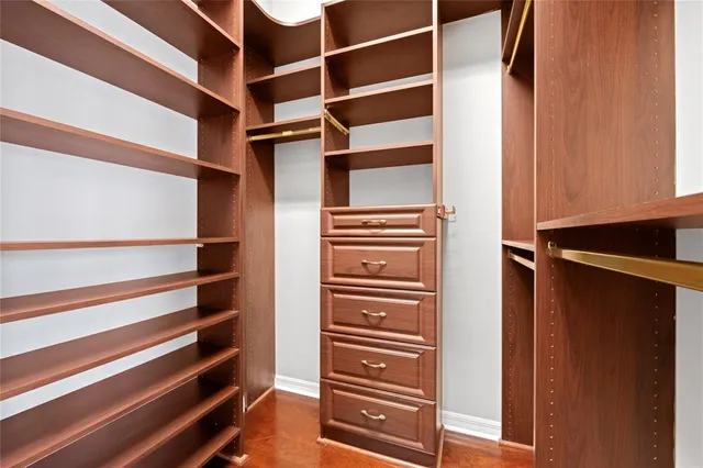 a view of walk in closet with empty racks