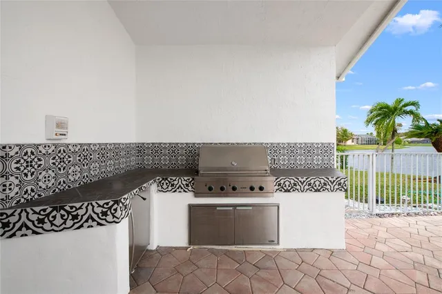 a view of a house with a patio and a yard