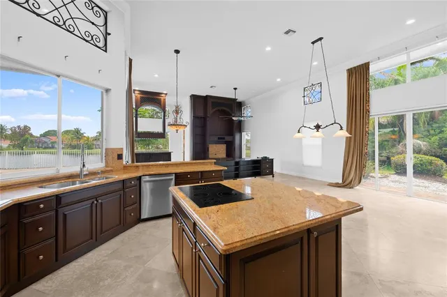 a kitchen with a sink a stove and a refrigerator