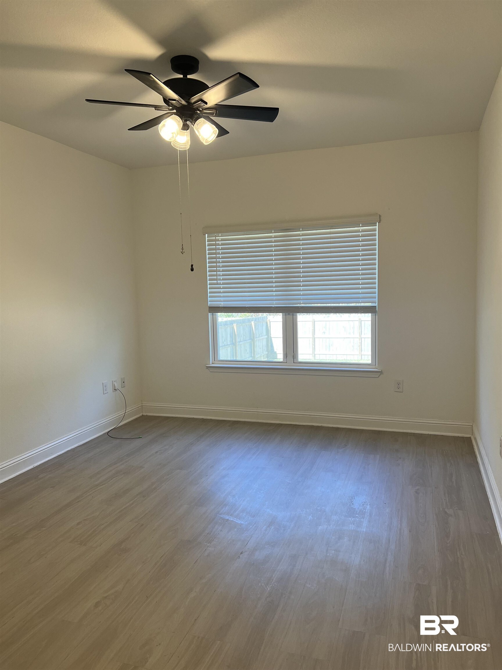 8855 Calverton Street Foley, AL 36535 - Photo 41 of 76 Unfurnished room with dark hardwood / wood-style floors and ceiling fan