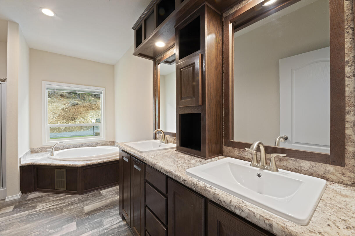 5572 Jumpoff Joe Creek Road Grants Pass, OR 97526 - Photo 12 of 38 a bathroom with a double vanity sink and a bathtub