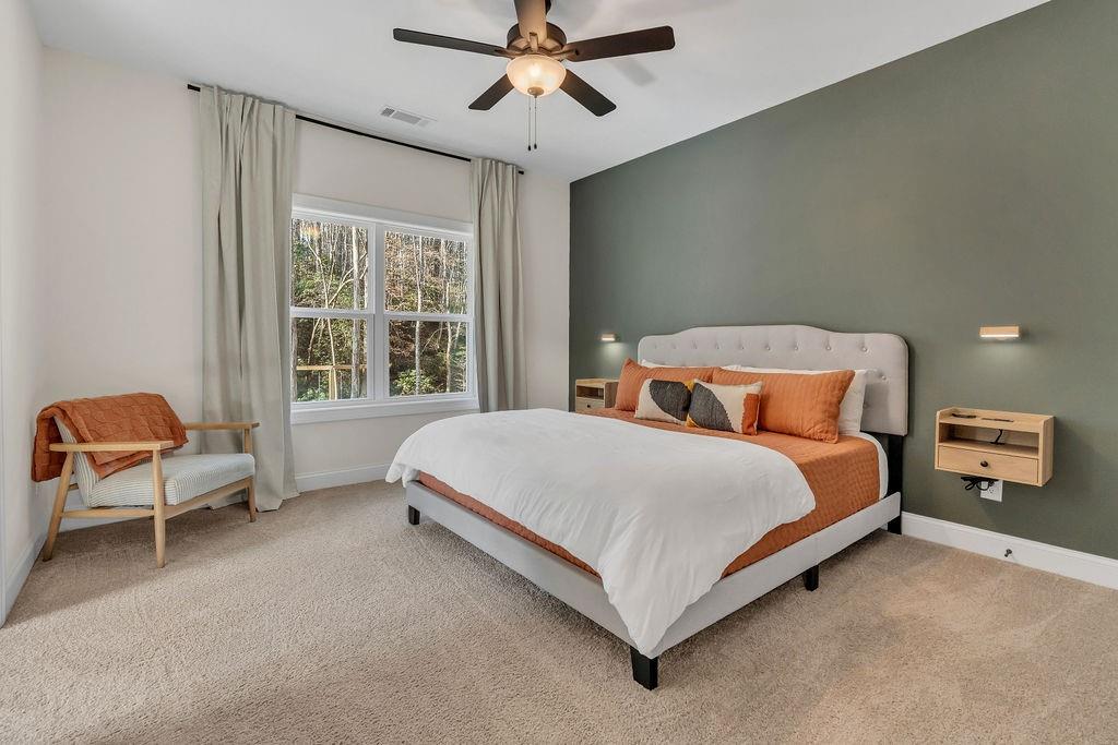 246 Woodward Way Talking Rock, GA 30175 - Photo 17 of 39 a bedroom with a bed and a chandelier