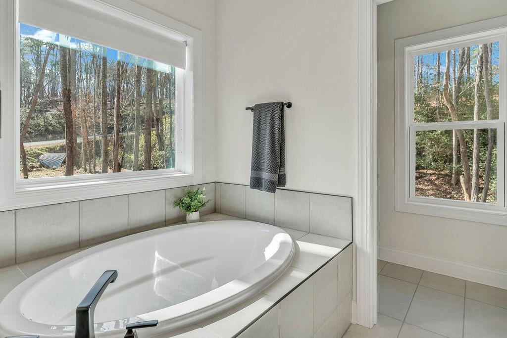 246 Woodward Way Talking Rock, GA 30175 - Photo 19 of 39 a bath tub sitting in a bathroom next to a window