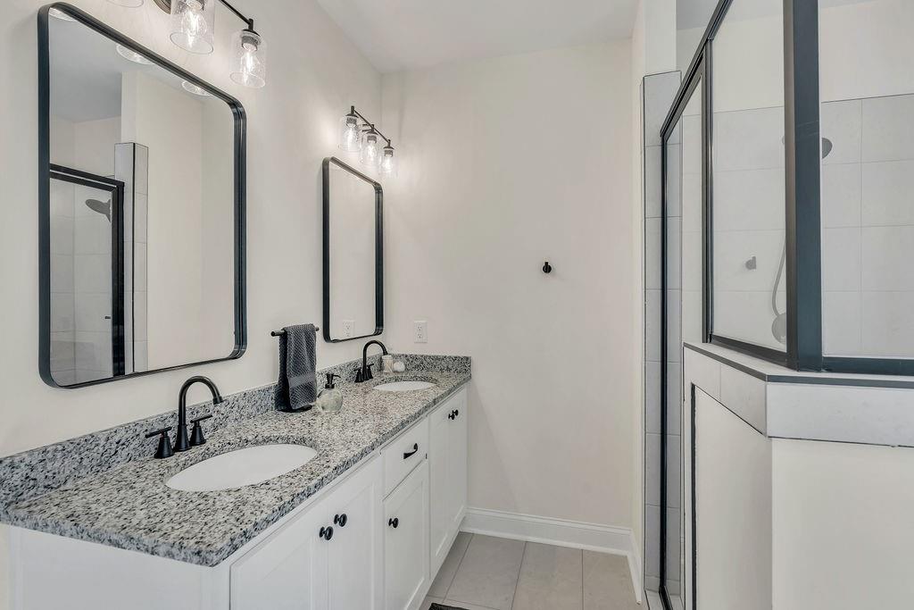 246 Woodward Way Talking Rock, GA 30175 - Photo 21 of 39 a bathroom with double vanity sinks and a mirror