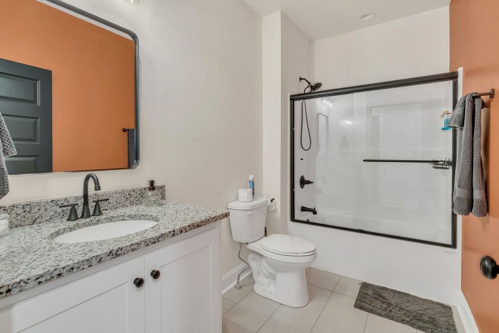 246 Woodward Way Talking Rock, GA 30175 - Photo 24 of 39 a bathroom with a granite countertop sink toilet and shower