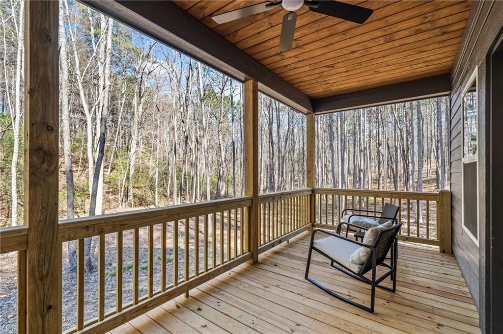 246 Woodward Way Talking Rock, GA 30175 - Photo 29 of 39 a balcony with wooden benches next to a yard