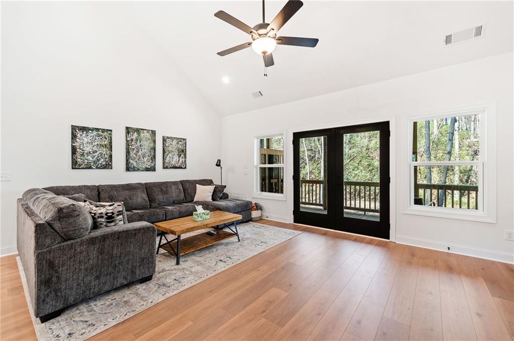 246 Woodward Way Talking Rock, GA 30175 - Photo 10 of 39 a living room with furniture and a large window with wooden floor
