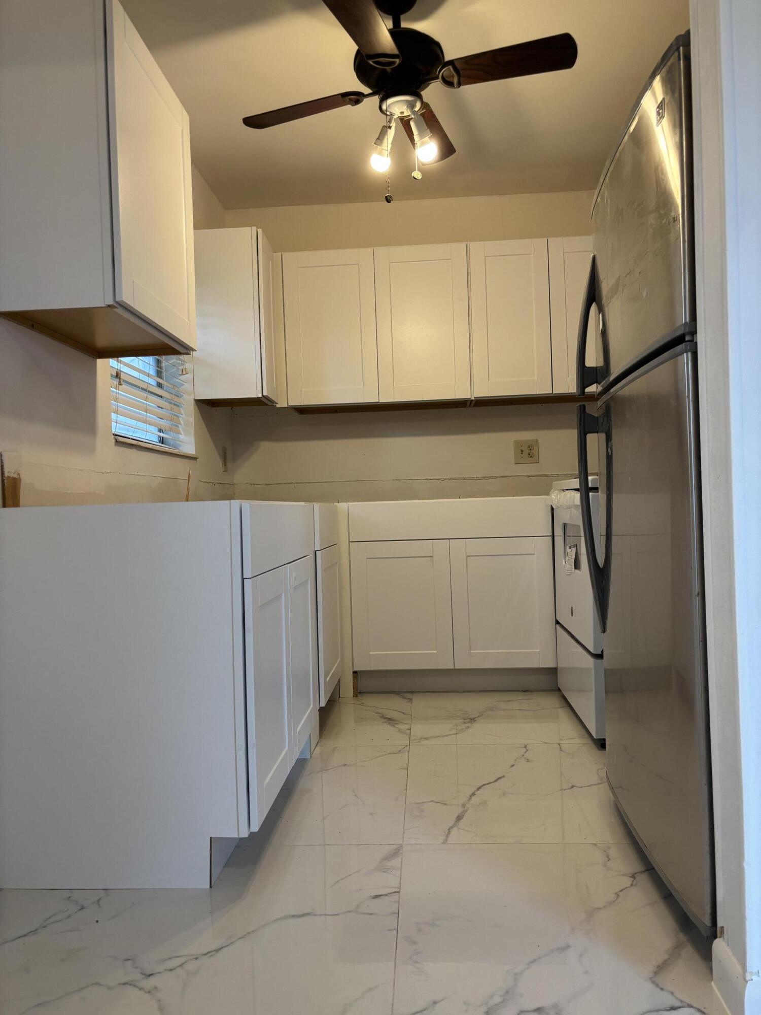 a kitchen with a refrigerator a sink and cabinets