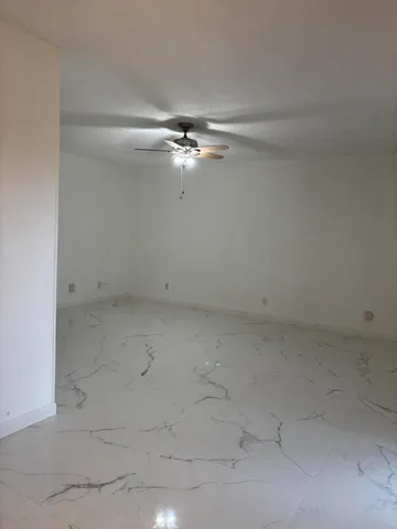 a view of a chandelier fan in an empty room