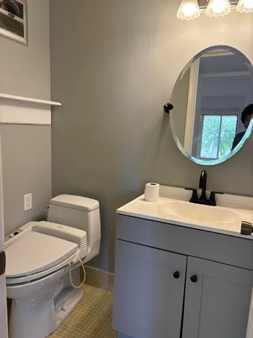 a bathroom with a toilet sink and shower
