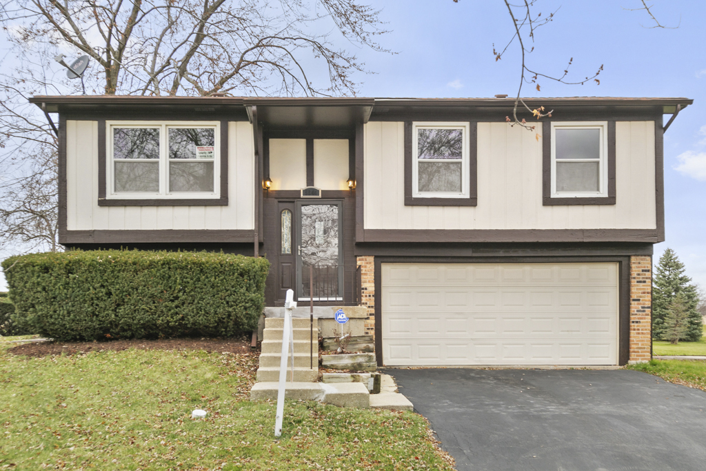 5644 Crestwood Road Matteson, IL 60443 - Photo 1 of 20 a front view of a house with garden