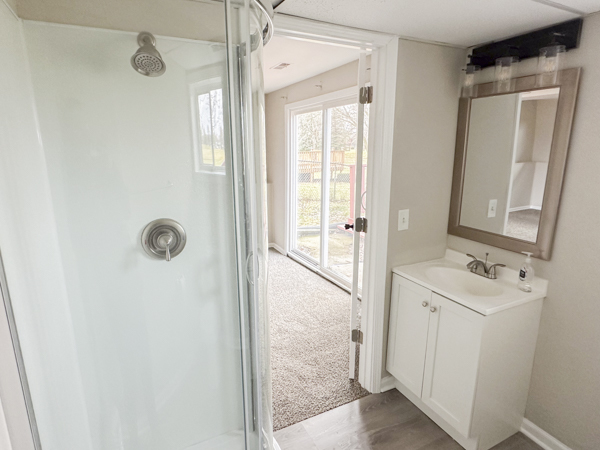 5644 Crestwood Road Matteson, IL 60443 - Photo 15 of 20 a bathroom with a shower sink and mirror