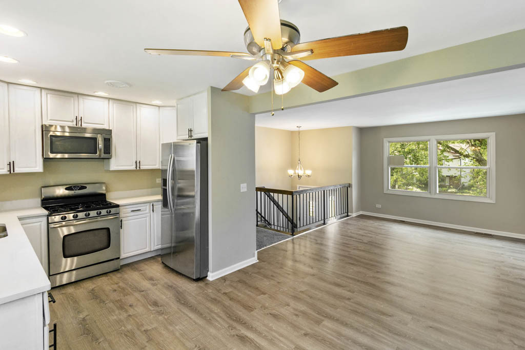 5644 Crestwood Road Matteson, IL 60443 - Photo 2 of 20 a kitchen with granite countertop a stove a refrigerator and a microwave