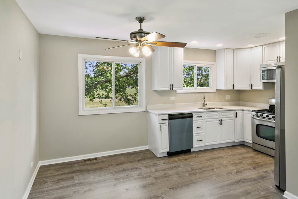 5644 Crestwood Road Matteson, IL 60443 - Photo 3 of 20 a kitchen with a stove a sink and a window