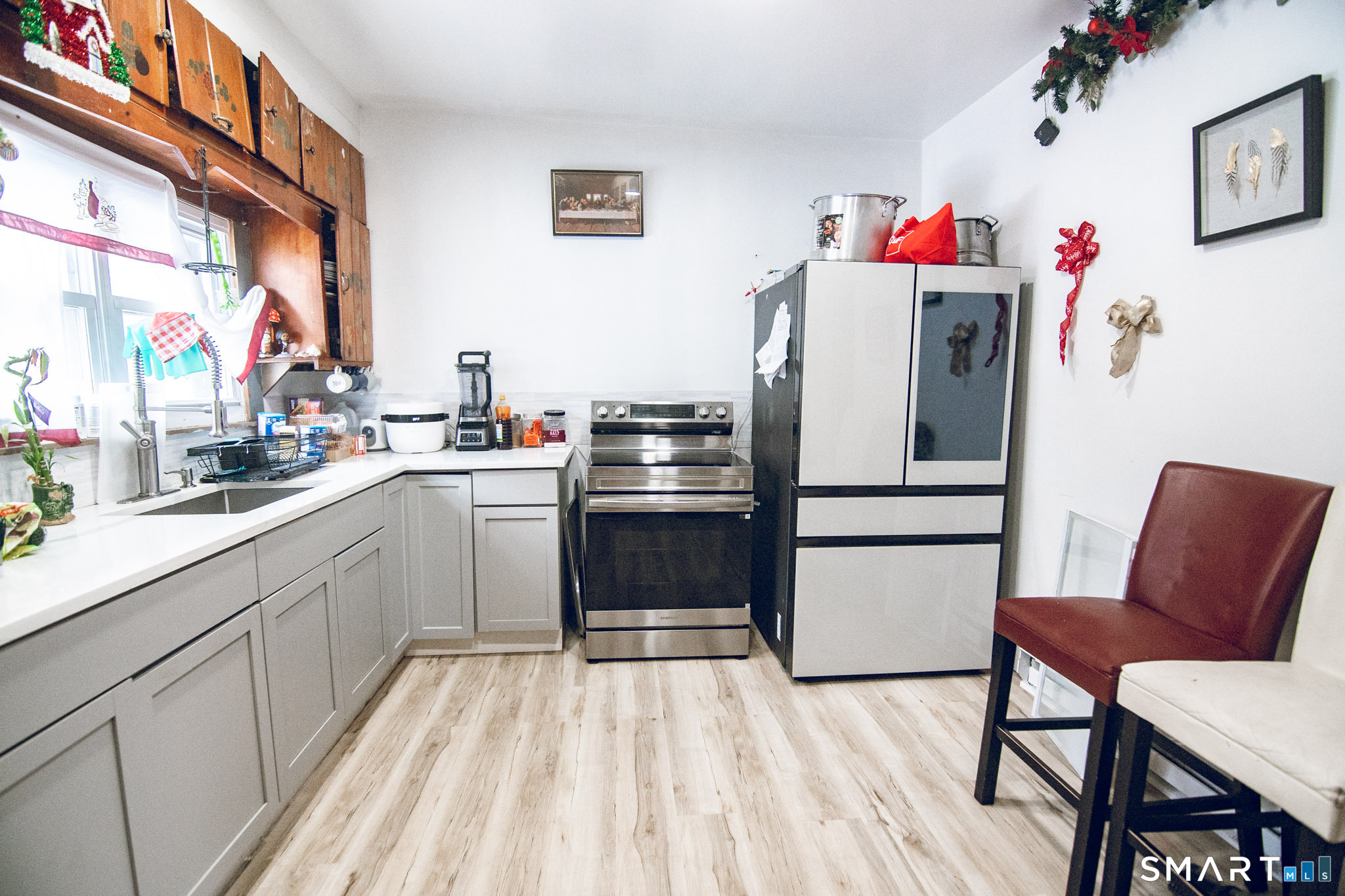 a kitchen with a refrigerator and table chairs
