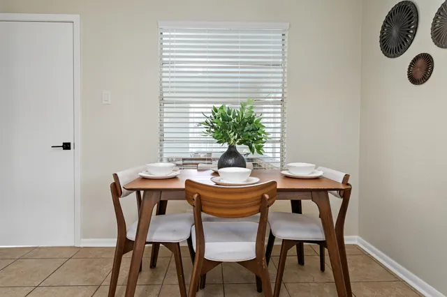 a dining room with furniture and window