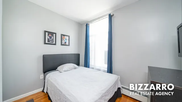 a view of a livingroom with wooden floor and cabinet