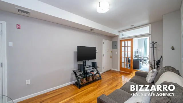 a kitchen with stainless steel appliances granite countertop a stove top oven a dining table and chairs with wooden floor