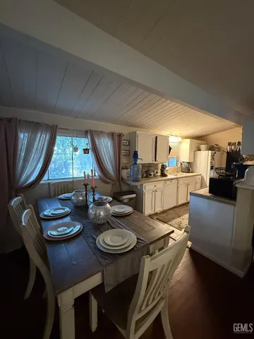 a kitchen with a dining table and chairs