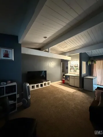 a view of a livingroom with furniture and a window