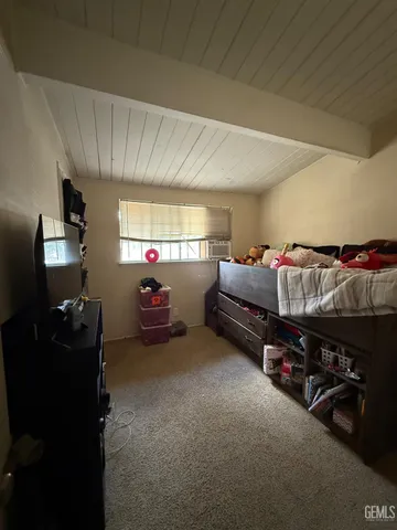 a living room with furniture a flat screen tv and gym equipment